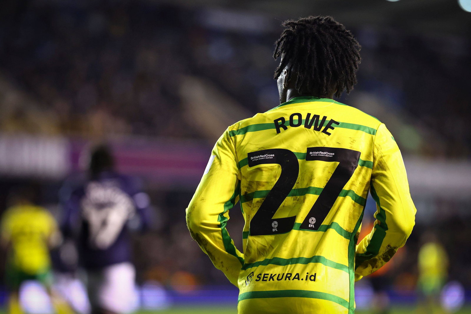 Jonathan Rowe jogging on the field, viewed from behind