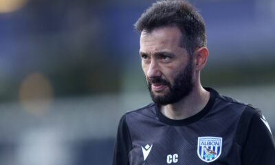 Carlos Corberán, West Bromwich Albion manager, standing confidently on the sidelines during a match.