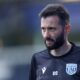 Carlos Corberán, West Bromwich Albion manager, standing confidently on the sidelines during a match.