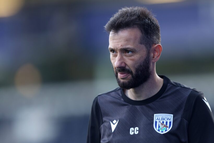 Carlos Corberán, West Bromwich Albion manager, standing confidently on the sidelines during a match.