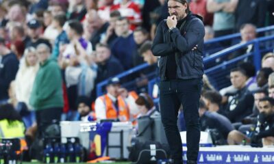 Daniel Farke on the sidelines during a Leeds United match, focused and determined.
