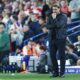 Daniel Farke on the sidelines during a Leeds United match, focused and determined.