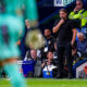 Daniel Farke deep in thought on the sidelines during a Leeds United match.